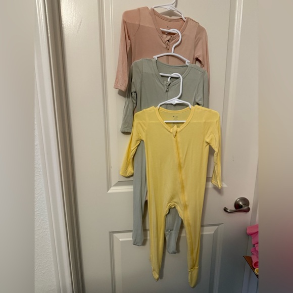 Set of 3 12-18 month Kyte baby zippered footie pajamas.